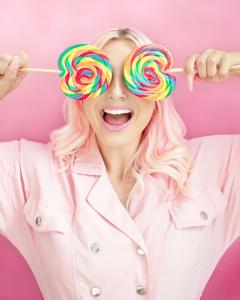 Clean Eating: Sugar topic - funny picture in colorful pink tones and two large colorful lollipops.